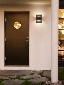 Geneve Grafit utelampa från Norlys - Den kubistiska formen och finishen i grafit ger ett mjukt ljus b&aring;de upp&aring;t och ned&aring;t, vilket skapar en behaglig atmosf&auml;r p&aring; fasader, i entr&eacute;er eller p&aring; uteplatser.