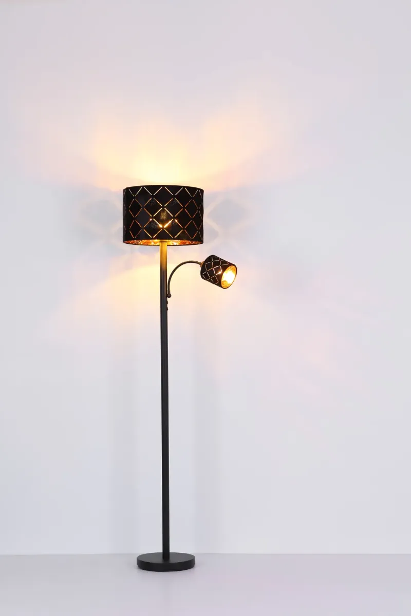 Sunna Svart golvlampa från Globo Lighting - Den runda stommen i h&ouml;gkvalitativ svart metall ger stabilitet och tidl&ouml;s charm, medan den svarta lampsk&auml;rmen i sammet med dekorativa utsk&auml;rningar tillf&ouml;r en lyxig k&auml;nsla och skapar ett fascinerande ljusspel.