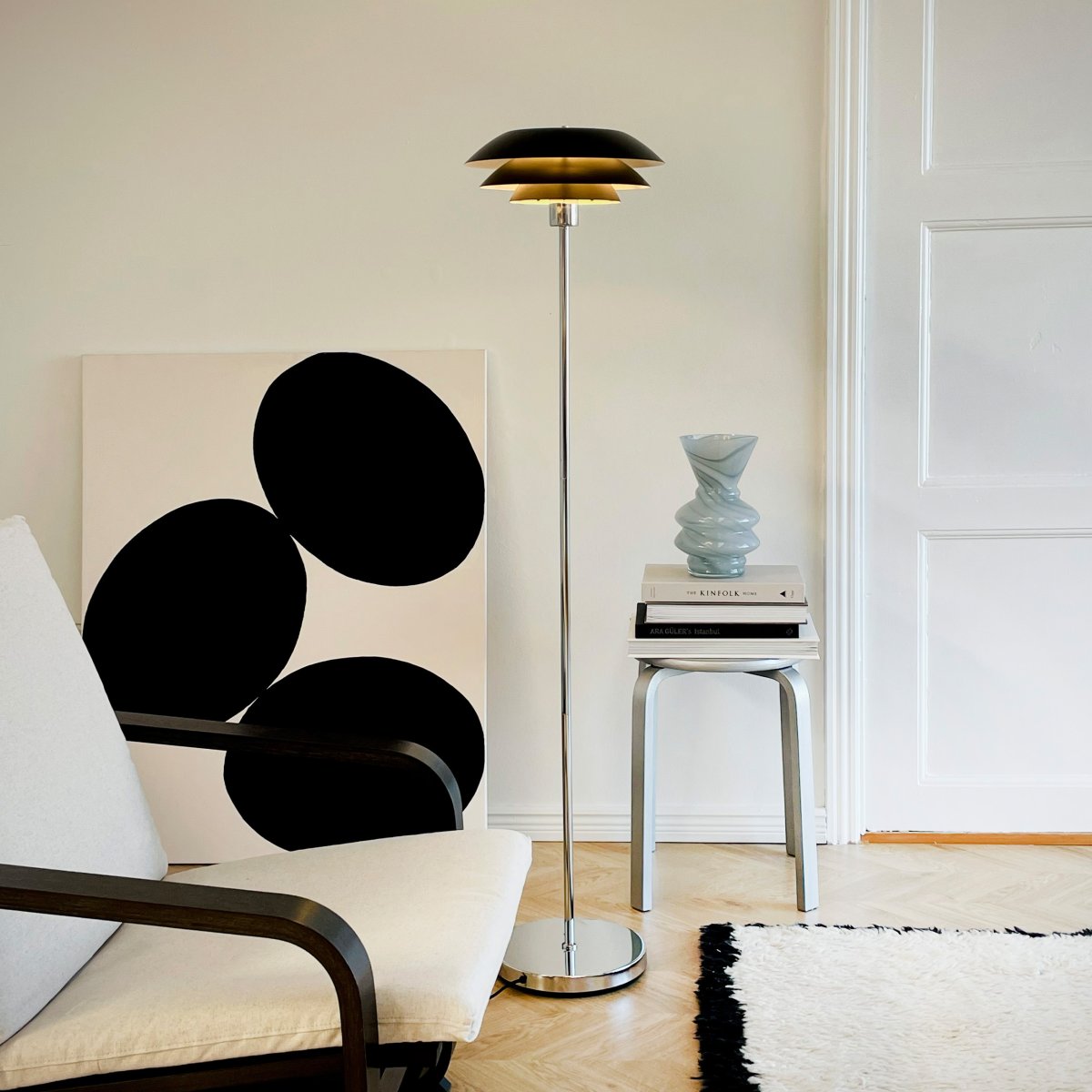 DL31 Svart golvlampa från Dyberg Larsen - Golvlampan &auml;r klassisk och dramatisk i svart f&auml;rg i kombination med kromad metall, perfekt f&ouml;r ett m&ouml;rkt h&ouml;rn i hemmet, bredvid soffan eller som en elegant inredningsdetalj i sig sj&auml;lv.