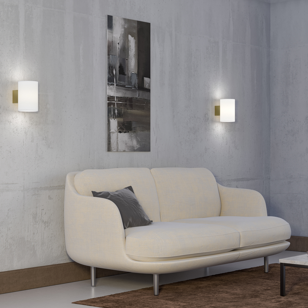 Evoke L Satinmässing/opal vägglampa från Herstal - Den smarta konstruktionen med b&aring;de upp- och nerljus g&ouml;r den till ett utm&auml;rkt val f&ouml;r att belysa din hall, vardagsrum eller sovrum p&aring; ett subtilt men effektfullt s&auml;tt.